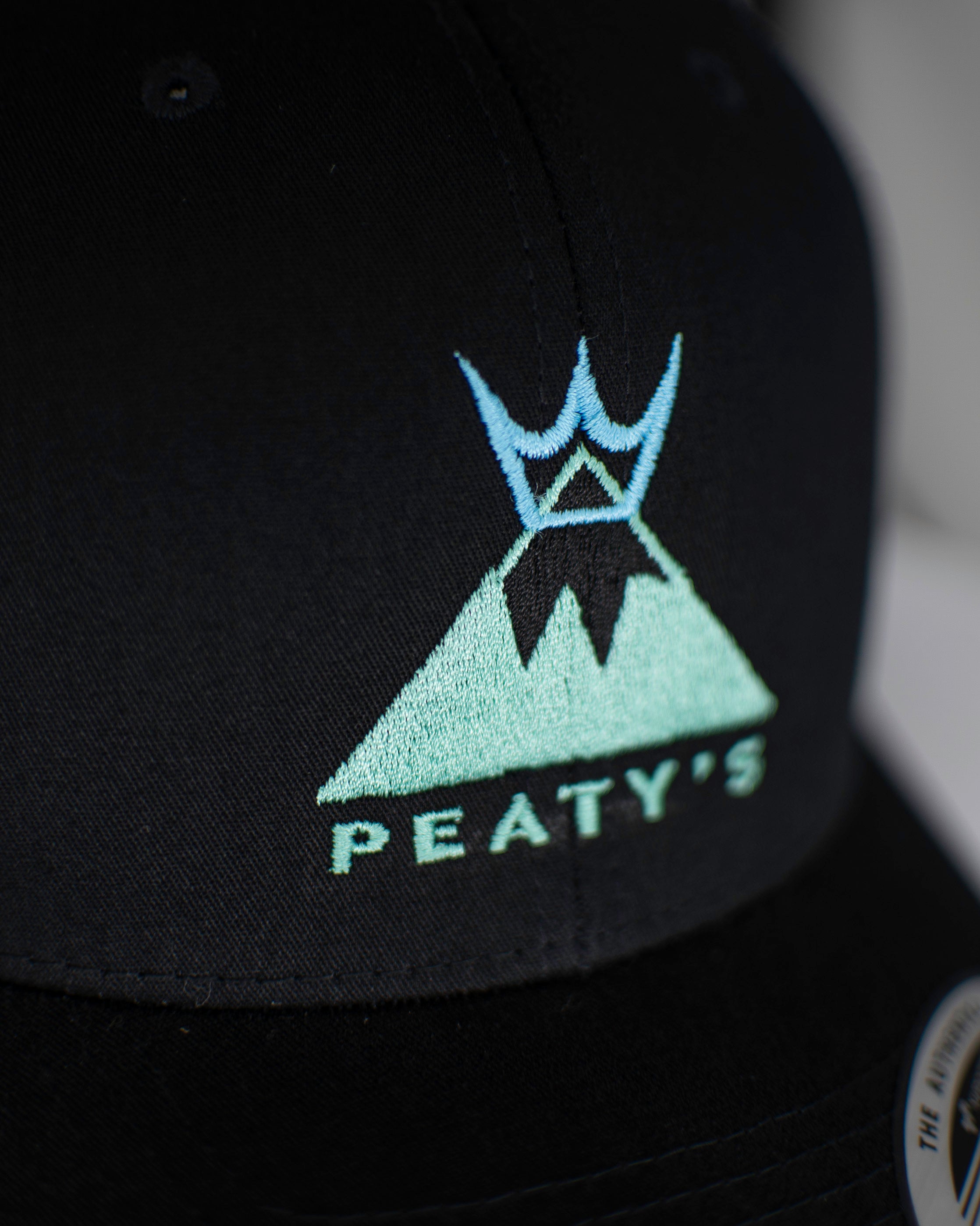 Summit cap in black embroidered logo detail